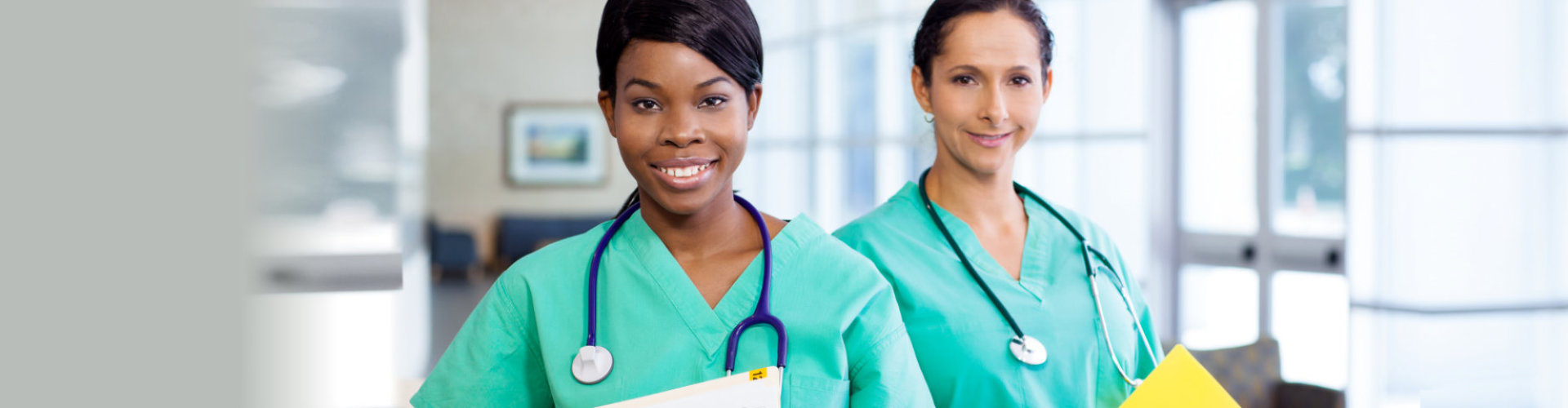 female nurses wearing stethoscopes smiling
