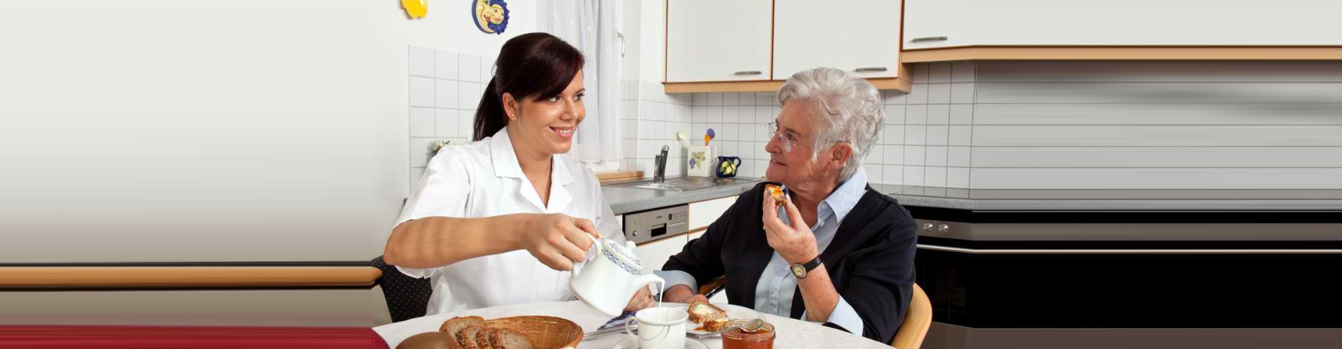 caregiver preparing meals to senior woman wearing eyeglasses smiling