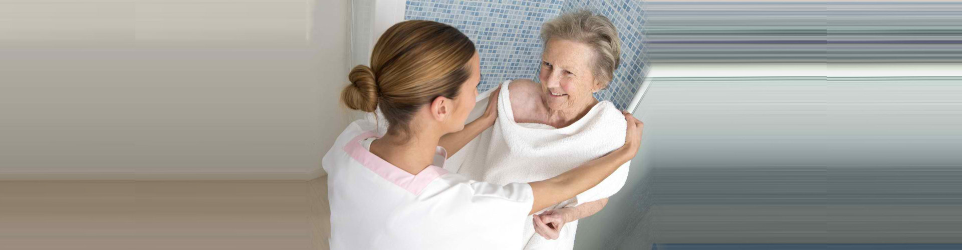 "caregiver assisting a senior woman bathing